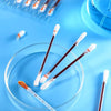 A collection of disposable medical iodine cotton swabs in various stages of use and storage on a blue background.