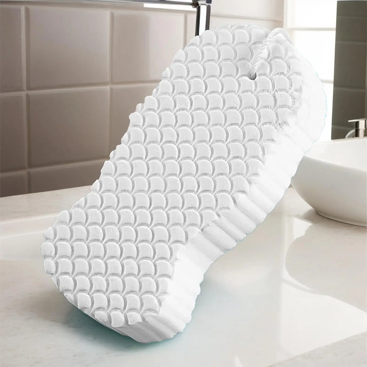 A white exfoliating bath sponge set is shown on a marble countertop.