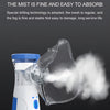 A clear plastic mesh nebulizer device is shown emitting a fine mist of fog.