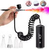 A hand holds a portable airbrush kit with a black hose and a cylindrical tank, showing the components for nail art and craft 