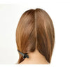 A close-up view of a person's hair with a professional dry hair trimmer being used on the back of the head.
