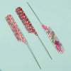 A set of three anti-static rat tail combs with pink and green floral patterns on a light blue background.