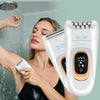 A woman is using a white 2-in-1 rotary body and facial hair remover device on her skin.