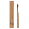 A single light brown bamboo toothbrush is shown next to its natural cardboard packaging.