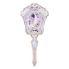 An antique pearl hand mirror with an ornate silver frame and a decorative inset featuring a purple bird.