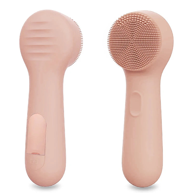 A pink silicone facial cleansing brush with a textured head and smooth body.