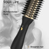 A black professional hair styling tool with a textured brush is shown against a woman's face and hair.