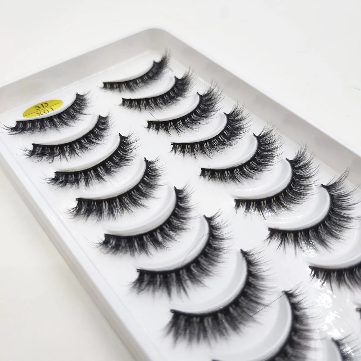 A tray of natural 3D mink false eyelashes displayed for sale.