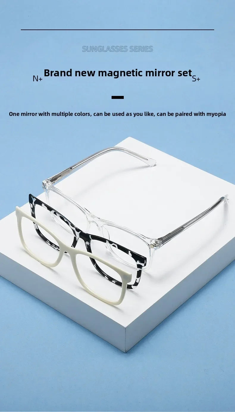 A pair of clear eyeglasses with black and white patterned frames is displayed on a white box.