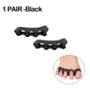 A pair of black silicone toe separators shown next to a foot for bunion relief.