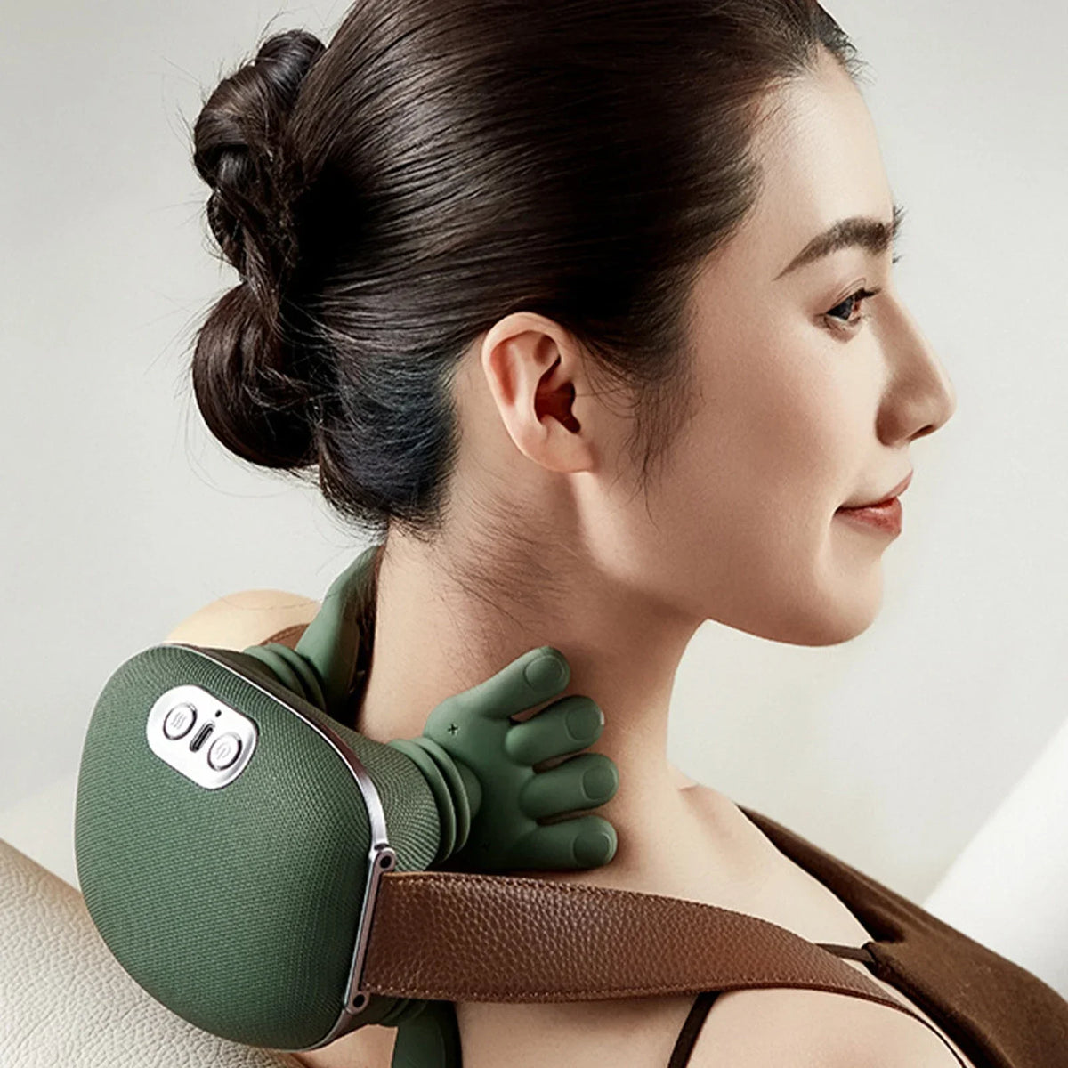 A woman wearing a green deep tissue shiatsu massager for neck and shoulder relief.