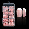 A clear plastic container holding nude pink press-on nails with white French tips.
