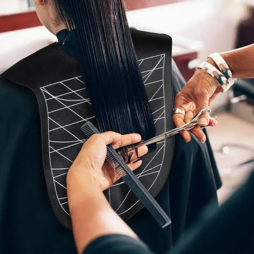 A person uses a reusable silicone hair dyeing cape and cutting collar to style hair.