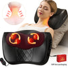 A woman is using an electric cervical and back shiatsu massage pillow on her neck and upper back.