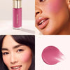 A pink liquid blush stick named Grace is shown next to a model applying it to her cheek and lips.