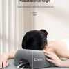 A hand is applying a gray ergonomic memory foam pillow with a 13cm height measurement to the back of a person's head.
