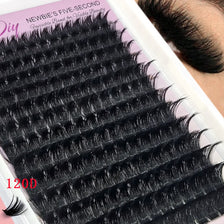 Close-up of black mink eyelash extensions being applied to an eye for beauty treatment.