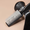 A black professional hair styling and cleaning brush set with a white bristles is shown against a light background.