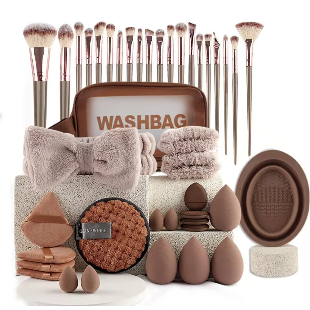 A collection of makeup brushes and tools, including various sizes and types, displayed in a brown washbag.