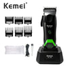 A black Kemei hair clipper trimmer set including multiple blades and a charging base.