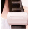 A pink hair curling iron is shown rolling out of a hair strand.