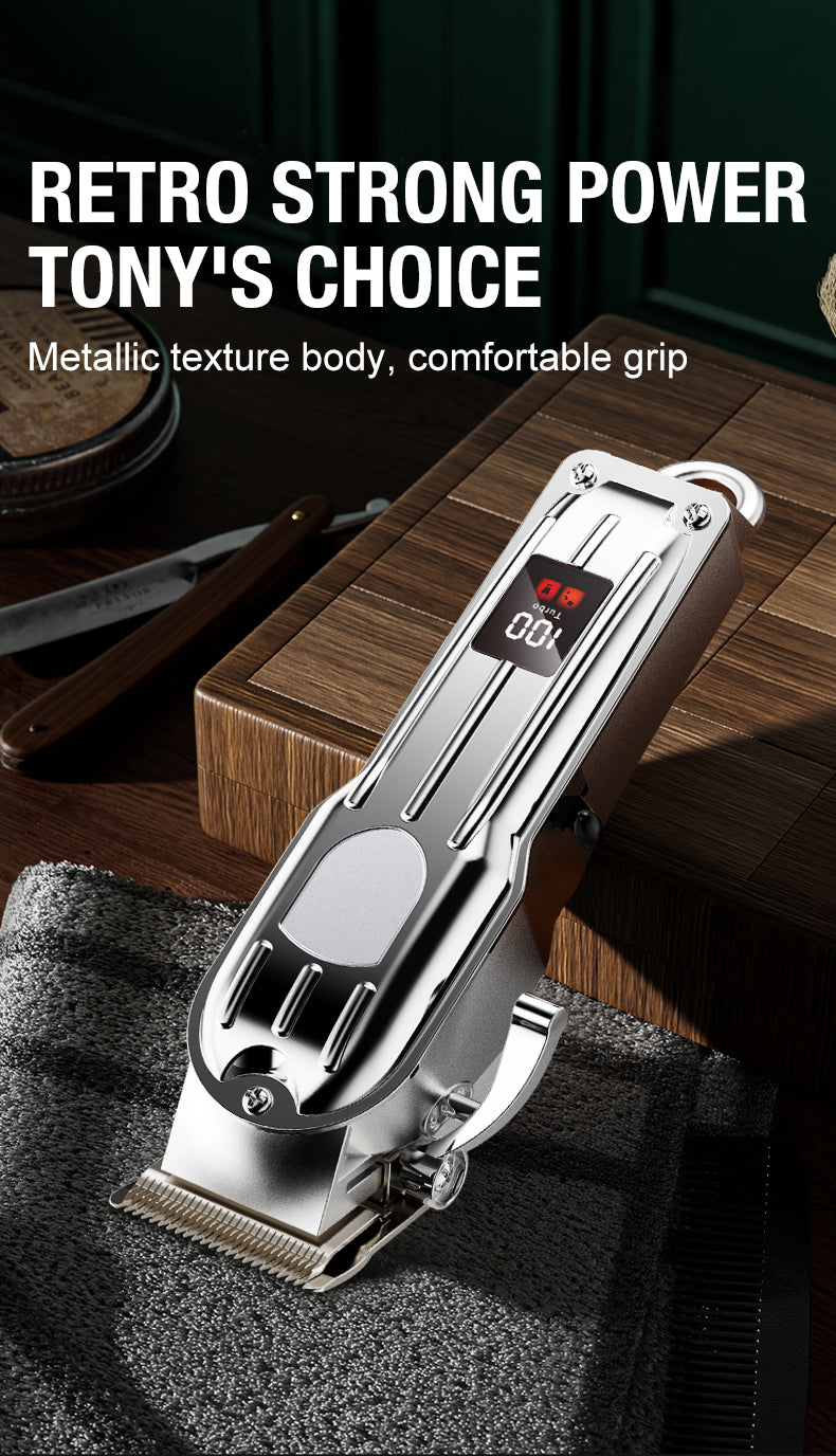A silver electric hair clipper with a metallic texture body and comfortable grip resting on a dark towel.